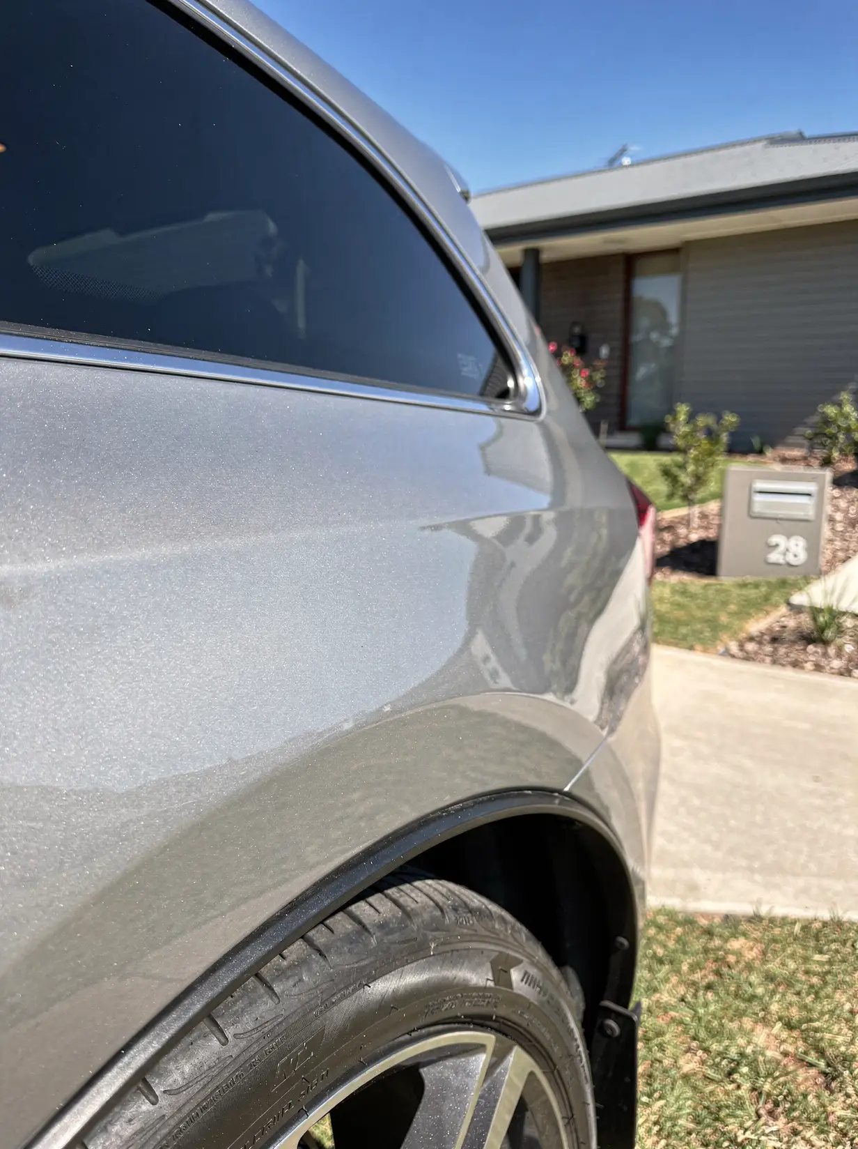 Mirror-shine metallic paint and polished wheel arch after O'Connor car detailing.