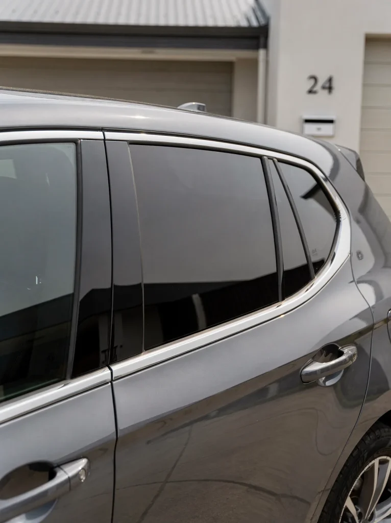 Paint-corrected car panel with mirror gloss and swirl-free clear coat, detailed in O'Connor.