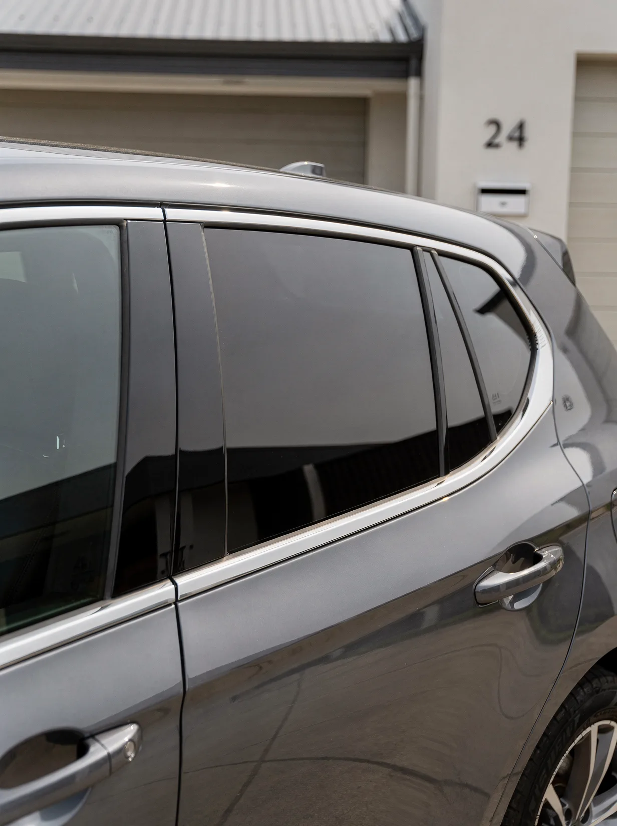 Paint-corrected car panel with mirror gloss and swirl-free clear coat, detailed in O'Connor.
